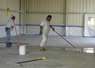 Coating industrial floor with epoxy.