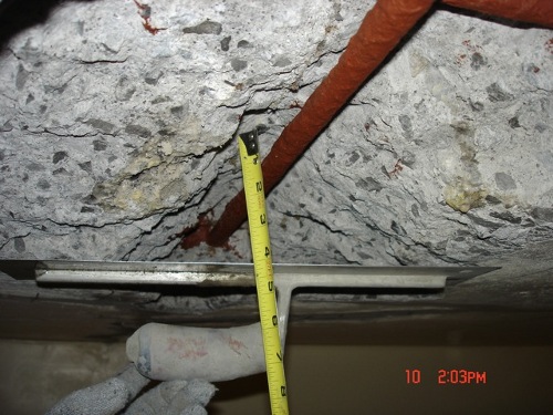 The overhead spall was 4 inches deep and was patched by hand.